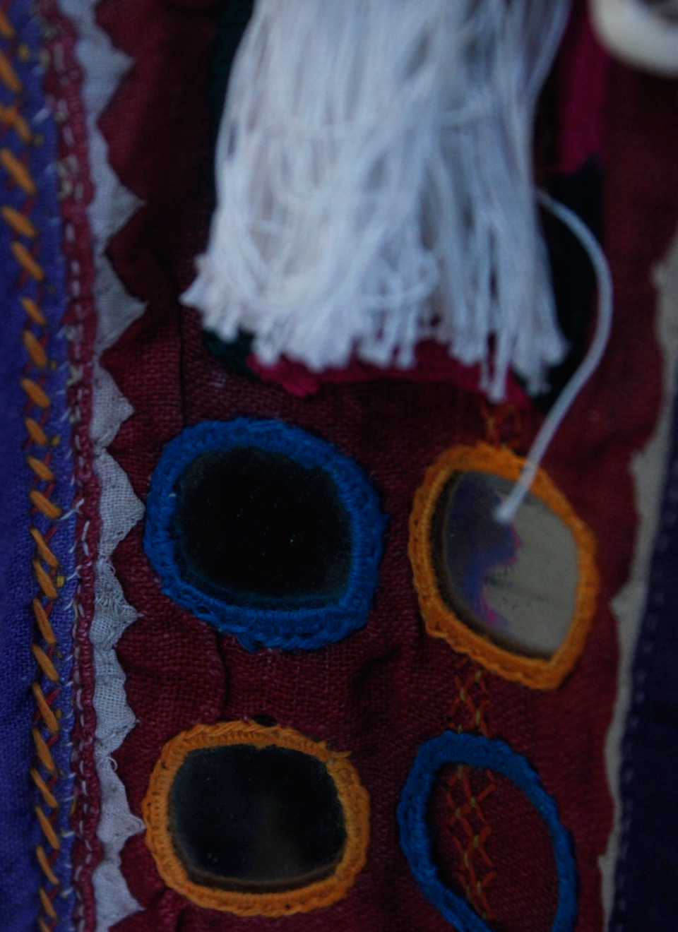 a Gujarati mirrored border with tassels - these kind of traditional Indian embellishments are popular accessories.