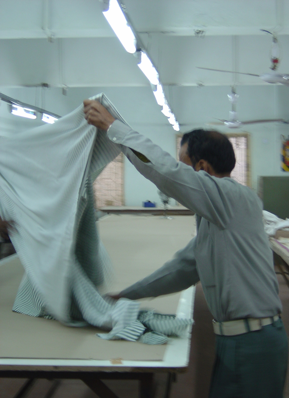 our erstwhile master, the late Jamil Ahmed, layering the fabric for machine cutting.